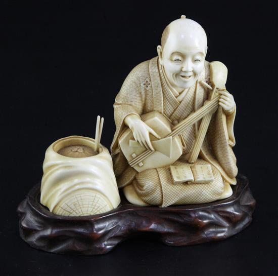 A Japanese ivory okimono of a kneeling musician, early 20th century, height 9.3cm, wood stand, damage to shamisen